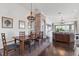Elegant dining room features shiplap and brick walls, a stylish chandelier, and access to the living area at 1294 Riverscape St # D, Bradenton, FL 34208