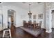 Elegant dining room features shiplap and brick walls, a stylish chandelier, and hardwood floors at 1294 Riverscape St # D, Bradenton, FL 34208