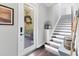 Inviting entryway features a white front door with glass and an elegant staircase with modern decor at 1294 Riverscape St # D, Bradenton, FL 34208