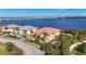 Stunning waterfront home with lush tropical landscaping and serene river views under a clear blue sky at 1294 Riverscape St # D, Bradenton, FL 34208