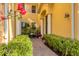 Charming front entrance features a brick path, lush greenery, and classic architectural details at 1294 Riverscape St # D, Bradenton, FL 34208