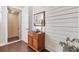 Hallway with custom wood accent wall, wooden floors, and an elevator with a glass door at 1294 Riverscape St # D, Bradenton, FL 34208