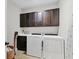 Convenient laundry room featuring a washer, dryer, upper and lower cabinets and a white countertop at 1294 Riverscape St # D, Bradenton, FL 34208