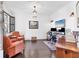 Bright home office with hardwood floors, shiplap walls, desk, and comfortable seating area at 1294 Riverscape St # D, Bradenton, FL 34208