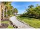 Scenic gravel path lined with lush greenery and trees at 1294 Riverscape St # D, Bradenton, FL 34208