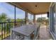 Inviting screened-in patio offering ample seating with a large table and beautiful water views at 1294 Riverscape St # D, Bradenton, FL 34208