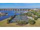 An aerial view of well-maintained tennis courts near the water and a marina, perfect for active residents at 1294 Riverscape St # D, Bradenton, FL 34208