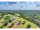 Expansive aerial view of a property with a home, pool, and lush greenery, providing a sense of privacy at 1668 Tropicaire Blvd, North Port, FL 34286