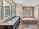 Bathroom featuring double vanity, standalone tub, and natural light from a glass block window at 1668 Tropicaire Blvd, North Port, FL 34286
