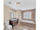 Bathroom featuring double vanity, standalone tub, and natural light from a glass block window at 1668 Tropicaire Blvd, North Port, FL 34286