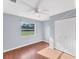 Bedroom featuring hardwood floors, window views, and ample closet space at 1668 Tropicaire Blvd, North Port, FL 34286