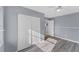 Bedroom offering hardwood floors, a ceiling fan, and closet space at 1668 Tropicaire Blvd, North Port, FL 34286