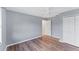 Bedroom featuring wood floors, a ceiling fan, and ample closet space at 1668 Tropicaire Blvd, North Port, FL 34286