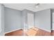 Light filled bedroom with hardwood floors, closet, and a ceiling fan at 1668 Tropicaire Blvd, North Port, FL 34286