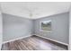 Bedroom featuring wood floors, a ceiling fan, and views from the window at 1668 Tropicaire Blvd, North Port, FL 34286