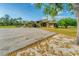 Spacious ranch home boasts tropical landscaping, a circular drive, and striking front door at 1668 Tropicaire Blvd, North Port, FL 34286