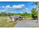 Expansive ranch home showcases lush tropical landscaping, circular drive, and a brilliant blue sky backdrop at 1668 Tropicaire Blvd, North Port, FL 34286