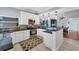 Updated kitchen featuring white cabinetry, dark countertops, and modern appliances at 1668 Tropicaire Blvd, North Port, FL 34286