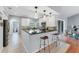 Well-lit kitchen with breakfast bar, modern cabinets, and view into the living area at 1668 Tropicaire Blvd, North Port, FL 34286