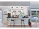 Modern kitchen featuring a breakfast bar, granite countertops, and stainless steel appliances at 1668 Tropicaire Blvd, North Port, FL 34286