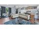 Inviting living room with a large sectional sofa, sleek coffee table, and hardwood floors at 1668 Tropicaire Blvd, North Port, FL 34286