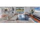 Bright living room with modern furnishings and view of outdoor pool through sliding glass doors at 1668 Tropicaire Blvd, North Port, FL 34286