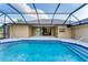 Backyard pool area with a screened enclosure offering seamless indoor-outdoor living and entertaining at 1668 Tropicaire Blvd, North Port, FL 34286