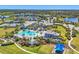 Aerial view of community, featuring a pool, lakes, landscaped greenery, and tennis courts at 17675 Azul Dr, Lakewood Ranch, FL 34202