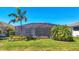 Secluded backyard oasis with screened pool, mature palms, and well-manicured landscaping at 17675 Azul Dr, Lakewood Ranch, FL 34202