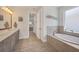 Bright bathroom with double vanity, soaking tub, and tile flooring at 17675 Azul Dr, Lakewood Ranch, FL 34202