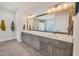 Spacious bathroom with double sinks, a large mirror, and modern fixtures at 17675 Azul Dr, Lakewood Ranch, FL 34202