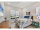 Cozy bedroom with natural light, floral bedding, and stylish furniture at 17675 Azul Dr, Lakewood Ranch, FL 34202