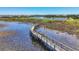 Picturesque boardwalk offering stunning views of the serene lake and surrounding nature preserve at 17675 Azul Dr, Lakewood Ranch, FL 34202