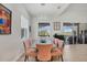 Bright dining room with modern lighting and seating for six with views of the backyard at 17675 Azul Dr, Lakewood Ranch, FL 34202