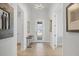 Bright and airy foyer with decorative wall art, tiled flooring, and a glass-paneled front door at 17675 Azul Dr, Lakewood Ranch, FL 34202