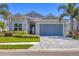 Charming single Gathering home with paver driveway, lush landscaping and a two-car garage at 17675 Azul Dr, Lakewood Ranch, FL 34202