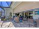 Shaded lanai with seating area, adjacent to the grill, and access to the yard and pool at 17675 Azul Dr, Lakewood Ranch, FL 34202