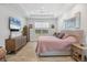 Bright main bedroom with hardwood floors, ceiling fan, and natural lighting at 17675 Azul Dr, Lakewood Ranch, FL 34202