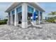 A pool cabana with an outdoor kitchen, bar and lounge seating for relaxing by the pool at 17675 Azul Dr, Lakewood Ranch, FL 34202