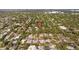 Drone shot of the property within a lush, tree-filled neighborhood, indicating a serene location at 2110 Euclid Ter, Sarasota, FL 34239