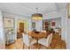 Dining room with decorative chandelier, wood floors, and a fireplace at 2110 Euclid Ter, Sarasota, FL 34239