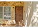 Close-up of the intricately carved wooden front door with stone accents at 2110 Euclid Ter, Sarasota, FL 34239