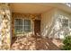 Charming front porch with stone accents, decorative wood door, and inviting tiled flooring at 2110 Euclid Ter, Sarasota, FL 34239