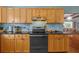Kitchen with wood cabinets and black countertops at 2110 Euclid Ter, Sarasota, FL 34239