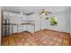 Charming kitchen featuring white cabinetry and neutral appliances, seamlessly flowing onto tile flooring at 2110 Euclid Ter, Sarasota, FL 34239