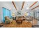Open living room with exposed beams, tile flooring, and tasteful furniture creating a warm atmosphere at 2110 Euclid Ter, Sarasota, FL 34239