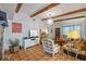 Comfortable living room featuring exposed beams, an entertainment center, and views into the kitchen at 2110 Euclid Ter, Sarasota, FL 34239