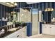 Luxurious bathroom featuring a glass shower enclosure and granite-topped vanity with double sinks at 21221 Wacissa Dr, Venice, FL 34293