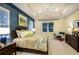 Serene bedroom with a tray ceiling, plush carpeting, and a large window offering natural light at 21221 Wacissa Dr, Venice, FL 34293