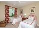 Charming bedroom featuring two twin beds with custom headboards, stylish curtains, and unique décor at 21221 Wacissa Dr, Venice, FL 34293